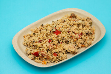 Sticker - Couscous with vegetables in a dish on blue