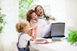 © famveldman - Mother working from home with kids.
