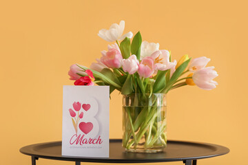 Sticker - Vase with tulips and greeting card for Women's Day on table near yellow wall