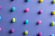 Image of multi coloured easter eggs with copy space on purple background