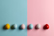 Image of multi coloured easter eggs with copy space on pink and blue background