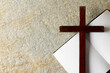 Image of close up of cross with notebook and copy space on stone background