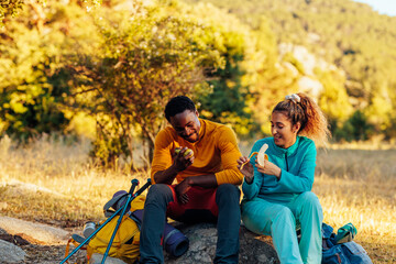 beautiful african american couple taking a break from hiking
