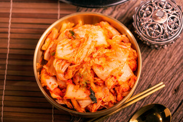 Wall Mural - Korean pickle and seasoning Spicy Kimchi Korean traditional food, Kimchi salad made with vegetable cabbage and pepper in golden bowl.