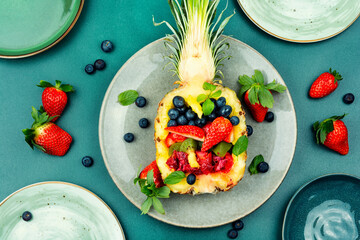 Wall Mural - Fruit salad in half a pineapple.