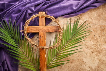 Wall Mural - Lent season, Holy week and Good friday concept. Palm leave and cross on stone background
