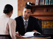 © Courtney H/peopleimages.com - Contract, signature and attorney consulting a client in his office with legal paperwork or agreement. Signature, approval and male lawyer in discussion with woman with a document to sign in workplace