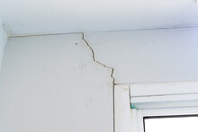 Wall Crack Near Window Frame In House Or Office Interior Building. Wall Concrete Broken From Structure Foundation Problem Concept.