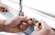 © Lumeez/peopleimages.com - Plumbing man, faucet and hands with screw for building maintenance, renovation and service. Closeup handyman, tap and plumber tools of engineering contractor, upgrade pipeline system or mechanic work