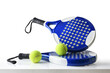 Set of paddle tennis rackets and balls on table isolated