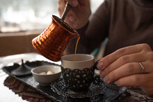 Close-up Of Hands Hold The Cup Of Turkish Coffee