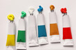 © New Africa - Tubes with oil paints on white canvas, flat lay