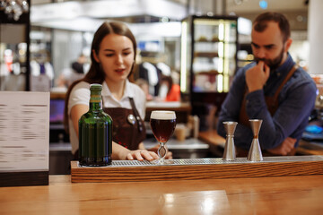 Two baristas work on creating coffee in a coffee shop