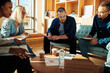 © Flamingo Images - Diverse businesspeople going over paperwork during an office meeting
