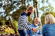 © Flamingo Images - Man pouring frineds wine at a picnic