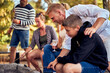 © Flamingo Images - Dad and son toasting marshmallows over a fire
