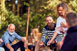 © Flamingo Images - Friends toasting marshmallows around a fire