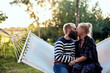 © Flamingo Images - Loving couple kissing on a hammock