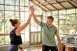 © Flamingo Images - Group of people high-fiving in gym