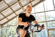 © Flamingo Images - Senior man exercising on a stationary bike in gym