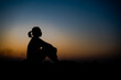 © stcom - Silhouette of a woman sitdown with so sad in the sunset.