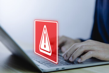 Wall Mural - businessman using laptop showing warning triangle and exclamation sign icon caution of dangerous pro