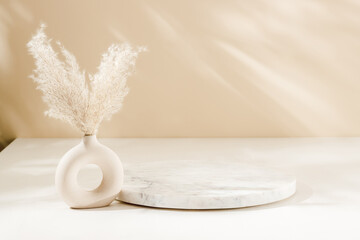 Marble round podium with vase and pampas grass, warm shadows. Display for home product presentation, aesthetic style