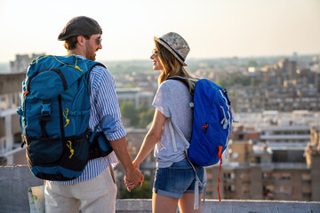 Happy couple on vacation sightseeing city with map. People travel fun honeymoon concept.