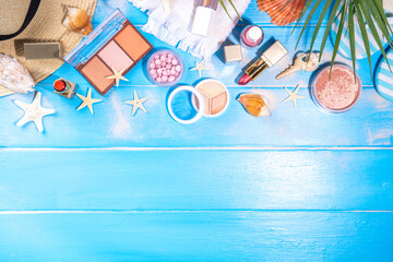 Wall Mural - Summer make-up cosmetics flat lay, Vacation, Holiday shopping sale make up.Shadows, lipstick, mascara, face powder, blush on blue wooden background with summer accessories, starfish, shells