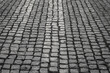 Close up image of old cobblestone road surface background texture. grey cobble stone. backdrop in perspective.