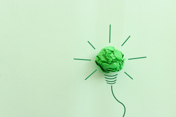 Wall Mural - Concept image of green crumpled paper lightbulb, symbol of scr, innovation and eco friendly business