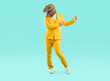 © Studio Romantic - Funny crazy man wearing dinosaur mask dancing at party. Full length shot of eccentric creative guy in yellow suit and ugly animal head mask dancing over isolated on studio background near copy space