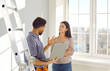 © Studio Romantic - Repairman talking to a woman at her home. Male worker standing by a step ladder, holding his laptop computer, talking to a young woman homeowner and asking about things he has to repair in the house
