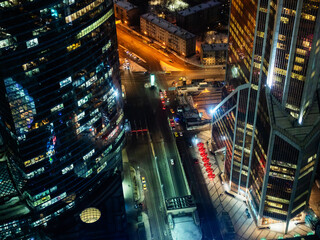 Wall Mural - above view of street and illuminated glass towers in Moscow city business district in evening from Imperia Tower