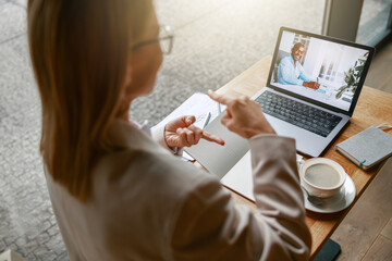 Wall Mural - Close up of businesswoman via videoconference discuss project with colleague use sign language 