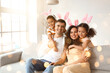 Happy interracial family in Easter bunny ears at home