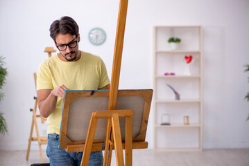 Wall Mural - Young man enjoying painting at home