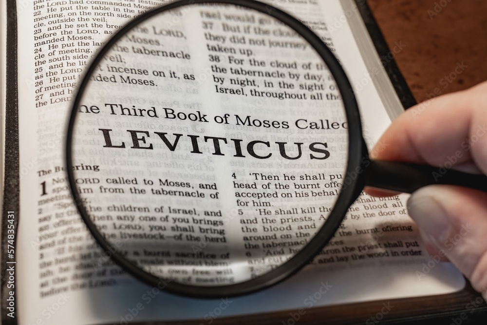 title page book of Leviticus close up using magnifying glass in the ...