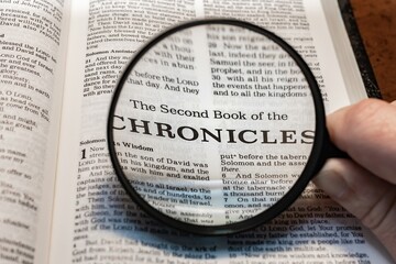 Wall Mural - title page book of second chronicles close up using magnifying glass in the bible or Torah for faith, christian, hebrew, israelite, history, religion, christianity, Old Testament