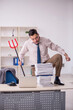 © Elnur - Young male employee unhappy with excessive work in the office