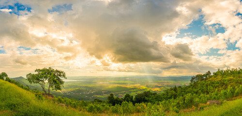 Wall Mural - Mountain landscape with sunset on the cloudy sk