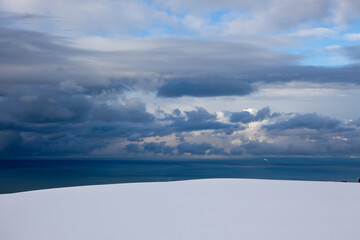  Black sea and clouds, winter landscape with sea view near Batumi, Georgia with white snow.