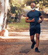 Music earphones, running and black man in nature for health, wellness and fitness. Radio, podcast and smile of happy senior athlete training, exercise and workout, cardio and jog outdoors at park.
