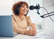 Laptop, microphone and radio with a black woman presenter talking during a broadcast while live streaming. Influencer, talk show and media with a female journalist or host chatting on a mic