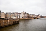 Fototapeta Paryż - Buildings in Paris, France along the Seine River in winter.