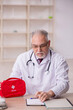 © Elnur - Old male doctor holding first aid bag