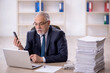 © Elnur - Old male employee and too much work in the office