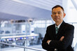 © DRN Studio - Asian middle-class businessman heading for an overseas business trip in the airport lobby.