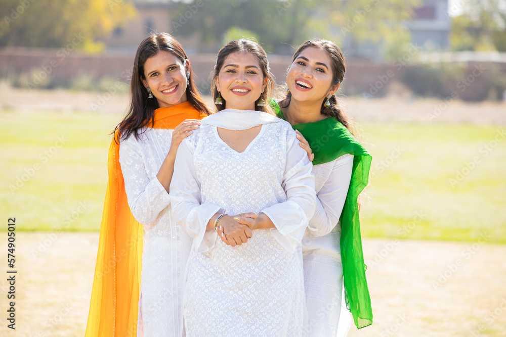 Indian Independence day or Republic day concept. Three happy young  beautiful woman wearing traditional white dress standing together at park  having fun. Stock Photo | Adobe Stock