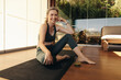 © Jacob Lund - Senior woman smiling at the camera on a yoga mat